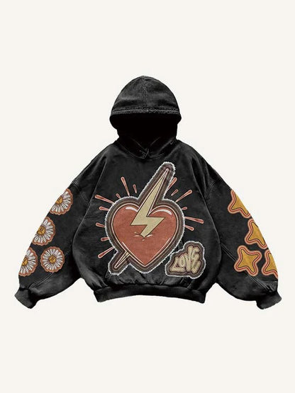 Black men’s hoodie with bold heart and lightning graphic, floral and star patches, clothbros