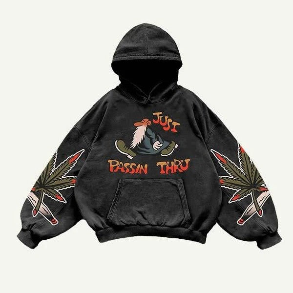 Black men’s hoodie with cartoon graphic, 'Just Passin Thru' text, and leaf illustrations on sleeves