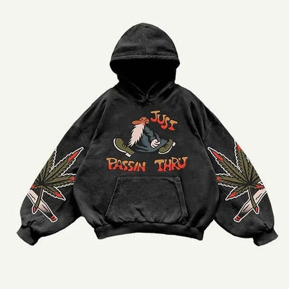 Black men’s hoodie with cartoon graphic, 'Just Passin Thru' text, and leaf illustrations on sleeves
